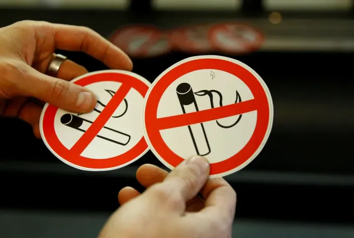 Framed Print : An employee shows no smoking signs in the Karas printing shop in Vienna Framed Print : An employee shows no smoking signs in the Karas printing shop in Vienna
