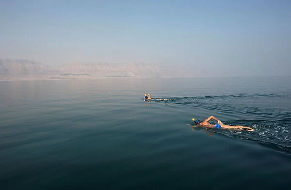 Environmental activists take part in The Dead Sea Swim Challenge, swimming