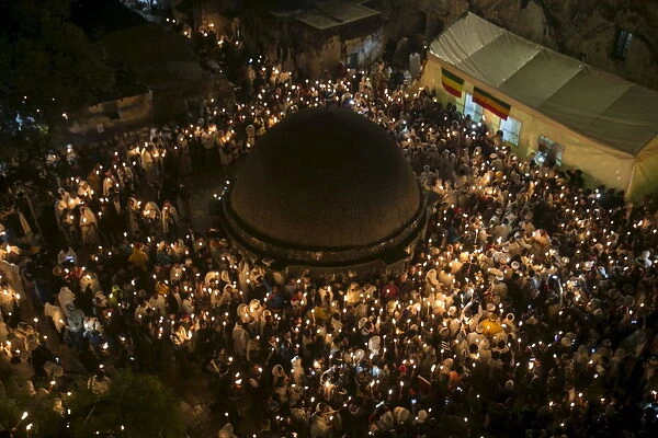 Ethiopian Orthodox worshippers hold candles during the Holy Fire ceremony in Jerusalem s