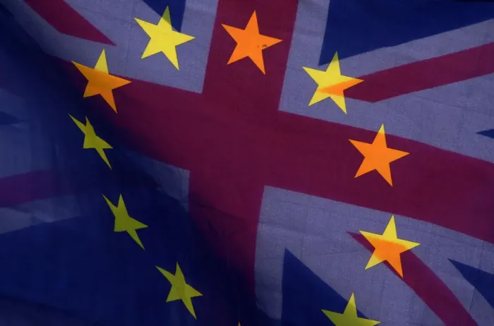 Framed Print : An EU flag and Union flag are seen flying together during an anti-Brexit protest near