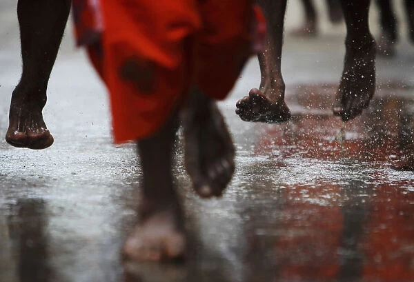 The feet of Hindu devotees are seen as they take part in a Bol Bom pilgrimage in