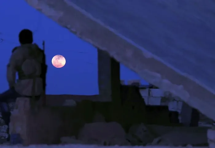Framed Print : A fighter from Free Syrian Army is seen watching a full moon rises in Daraa Framed Print : A fighter from Free Syrian Army is seen watching a full moon rises in Daraa