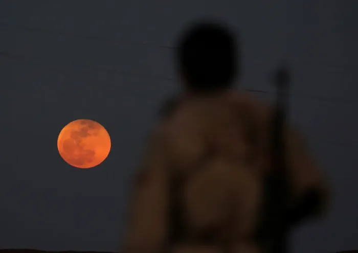Framed Print : A fighter from Free Syrian Army is seen watching a full moon rises in Daraa Framed Print : A fighter from Free Syrian Army is seen watching a full moon rises in Daraa