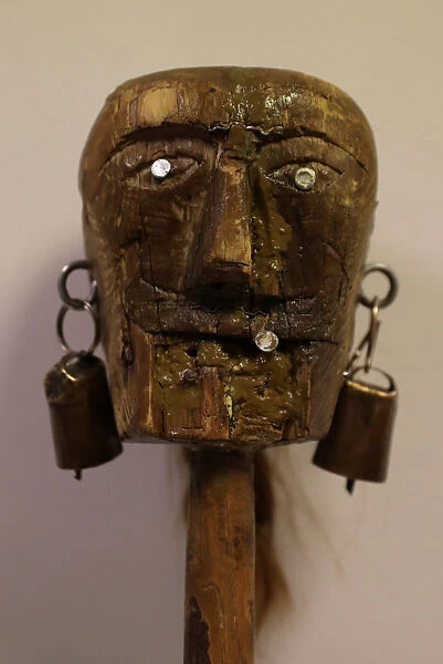 A figure on the top of a stick used by a believer is seen before the Endiablada
