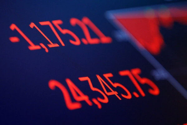 The final numbers of the day are shown above the floor of the New York Stock Exchange in