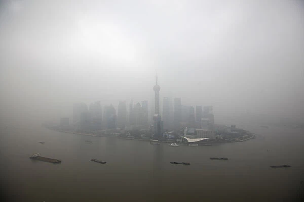The financial district of Pudong is seen on a hazy day in Shanghai