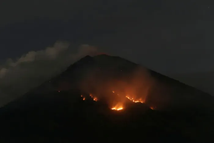 Framed Print : Fire is seen on the slopes of Mount Agung volcano following an eruption as seen from Amed Framed Print : Fire is seen on the slopes of Mount Agung volcano following an eruption as seen from Amed