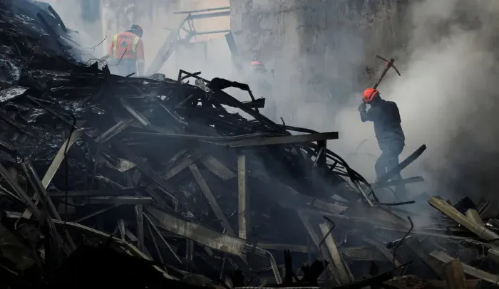 Framed Print : Firefighters try to extinguish a fire of a building that caught fire Framed Print : Firefighters try to extinguish a fire of a building that caught fire