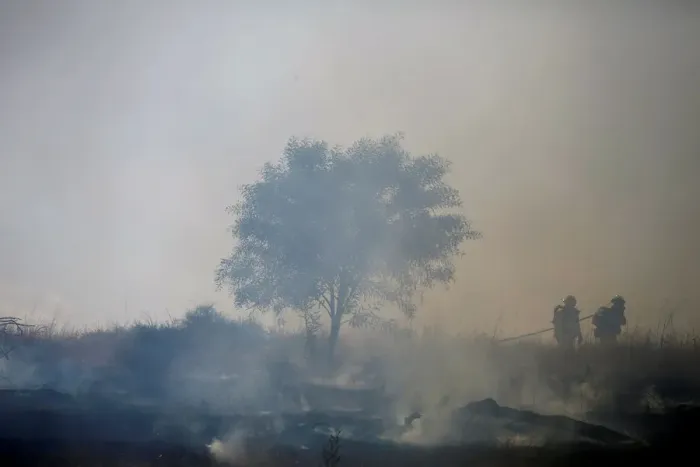Framed Print : Firefighters try to extinguish fire on the Israeli side of the border fence between Framed Print : Firefighters try to extinguish fire on the Israeli side of the border fence between