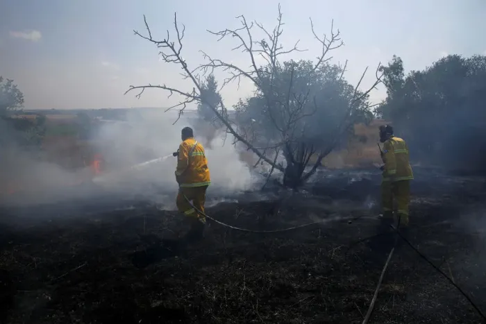 Framed Print : Firefighters try to extinguish fire on the Israeli side of the border fence between Framed Print : Firefighters try to extinguish fire on the Israeli side of the border fence between