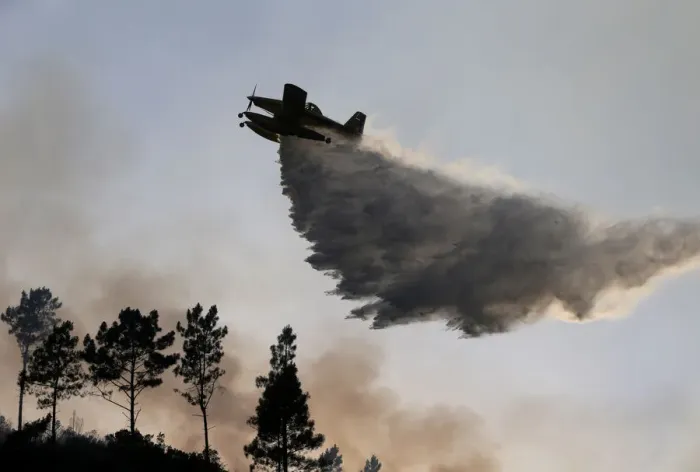 Framed Print : A firefighting plane dumps water on a forest fire in Mendeira Framed Print : A firefighting plane dumps water on a forest fire in Mendeira