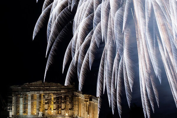 Fireworks explode over the ancient Parthenon temple atop Acropolis hill during New