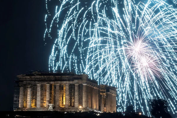 Fireworks explode over the ancient Parthenon temple atop the Acropolis hill during