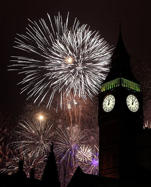 Fireworks explode behind the Big Ben clock tower during New Year celebrations in London