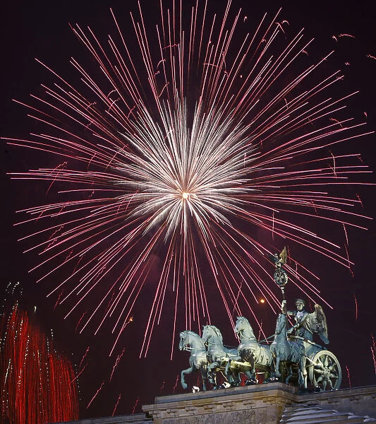 Fireworks explode above the Quadriga atop the Brandenburg Gate during New Year celebrations