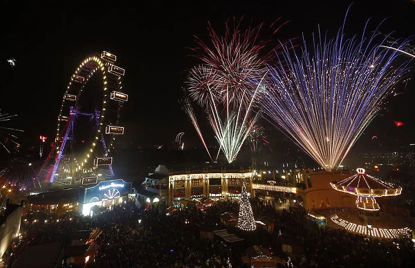Fireworks explode beside Viennas Giant Ferris Wheel at Prater park during New Year