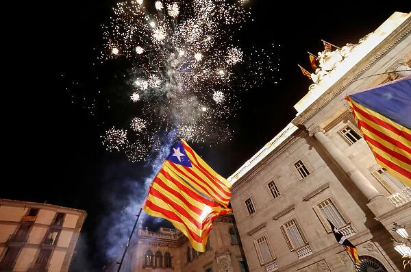 Fireworks go off in front of the Catalan regional government headquarters during