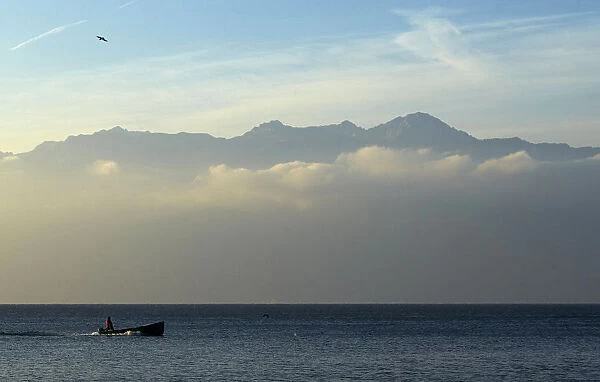 A fisherman sails early morning on Lake Leman in Lutry