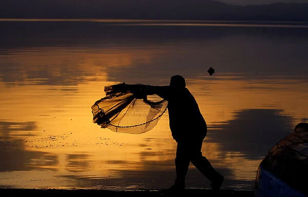 A fisherman uses his net at Lake Ohrid in Ohrid