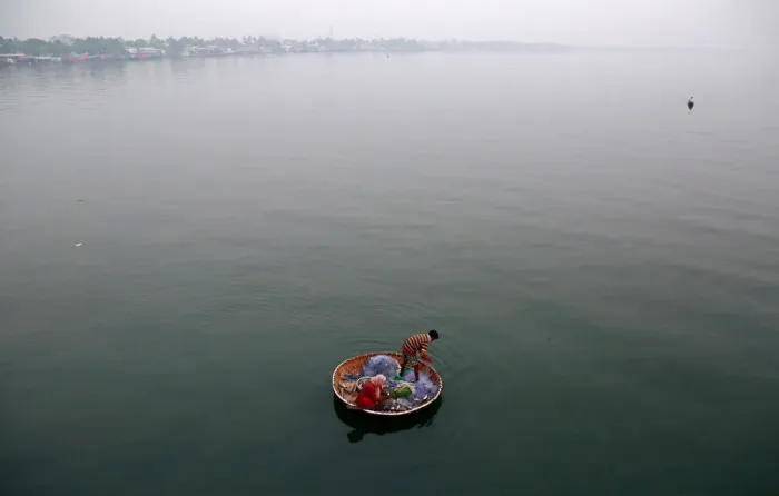 Framed Print : A fisherman and his wife catch fish in the waters of Vembanad Lake in Kochi Framed Print : A fisherman and his wife catch fish in the waters of Vembanad Lake in Kochi