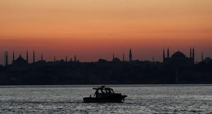 Framed Print : A fishing boat sails in the Bosphorus as the sun sets over the old city in Istanbul Framed Print : A fishing boat sails in the Bosphorus as the sun sets over the old city in Istanbul