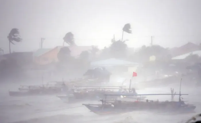 Framed Print : Fishing boats are pictured amid heavy winds and rain brought by Typhoon Rammasun as