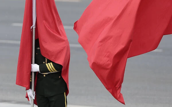 Flag is seen covering the face of a honor guard during a welcoming ceremony for the