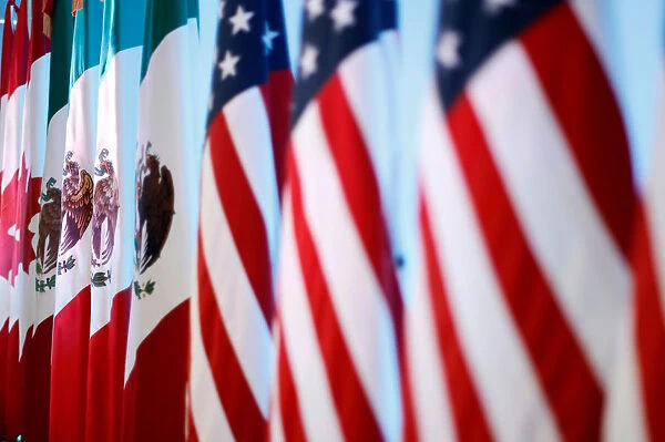Flags of Canada, Mexico and the U. S. are seen before a joint news conference on the