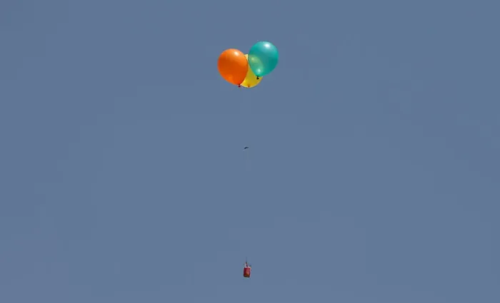 Framed Print : Flaming balloons are released by Palestinian demonstrators to the Israeli side during a Framed Print : Flaming balloons are released by Palestinian demonstrators to the Israeli side during a