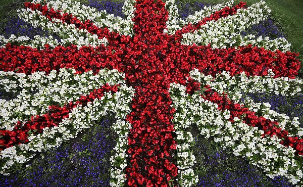 A floral display in the design of a British Union Jack flag is seen by the side of