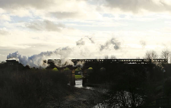 The Flying Scotsman steam engine passes over a viaduct as it leaves East Lancashire