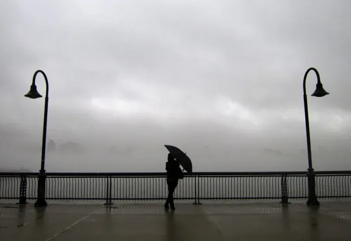 Framed Print : Fog shrouds the skyline of New York as a woman stands next to the Hudson River on a pier Framed Print : Fog shrouds the skyline of New York as a woman stands next to the Hudson River on a pier