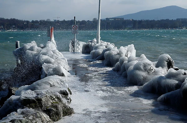 A frozen pier is seen during a windy winter day near Lake Leman in Geneva