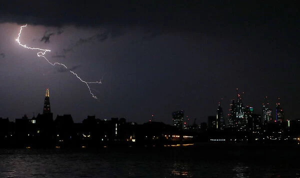 General view as lightning strikes over the city of London, Britain