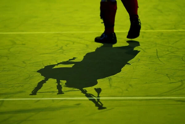 General view of a performer and their shadow on the court before the start of play