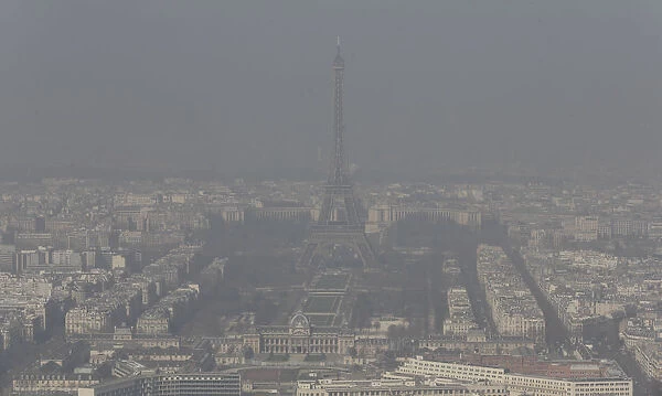 A general view shows the Eiffel tower and the Paris skyline through a small-particle haze
