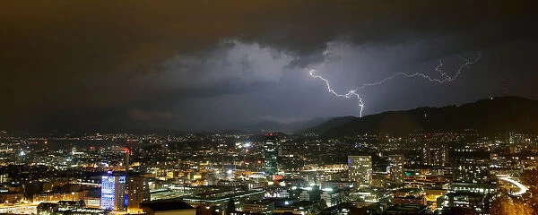 A general view shows lightning over the city of Zurich