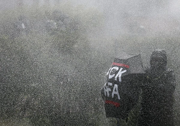 German police use water cannons against right-wing protestors during a demonstration in