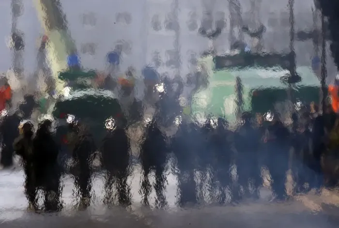 Framed Print : German policemen are seen through the heat haze of a burning barricade during a protest Framed Print : German policemen are seen through the heat haze of a burning barricade during a protest