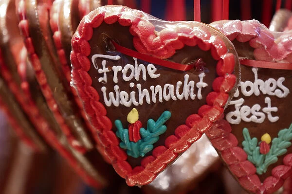 Gingerbread hearts, decorated with icing reading Merry Christmas are displayed for