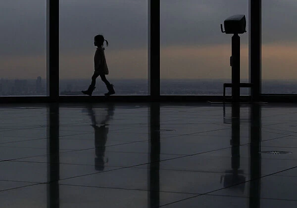 A girl walks at an observation deck in Tokyo