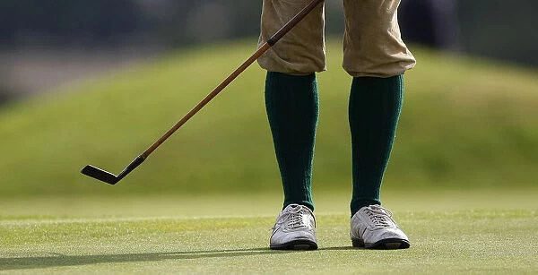 A golfer makes a practice swing with his hickory club during the World Hickory Golf