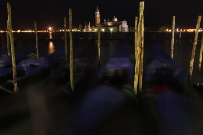 Framed Print : Gondolas are seen along the Canal Grande in front of San Giorgio Maggiore church in