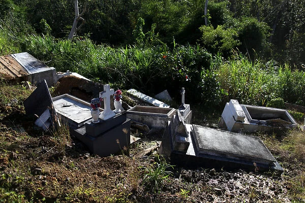 Graves destroyed during Hurricane Maria in September 2017, are seen at a cemetery