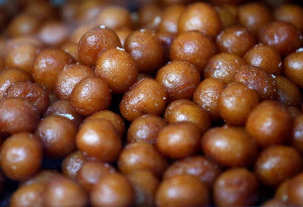 Gulab jamuns (traditional Indian sweet) are on display for sale at a sweets shop in