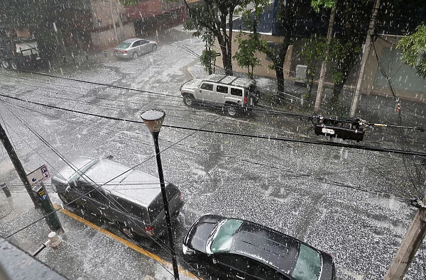 Hail falls on a street during rain in Mexico City
