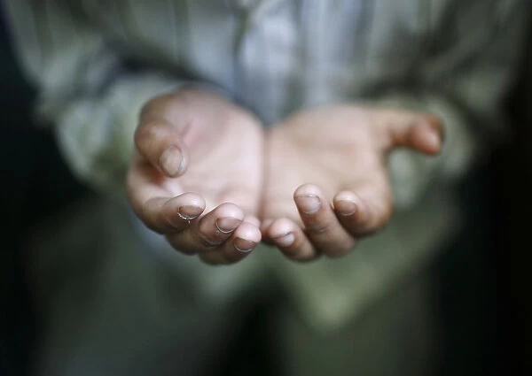 A hand of a Muslim boy offering prayer is pictured during the holy fasting month of