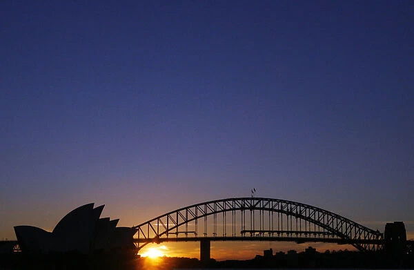 The Harbour Bridge and the Sydney Opera House are seen at sunset in Sydney