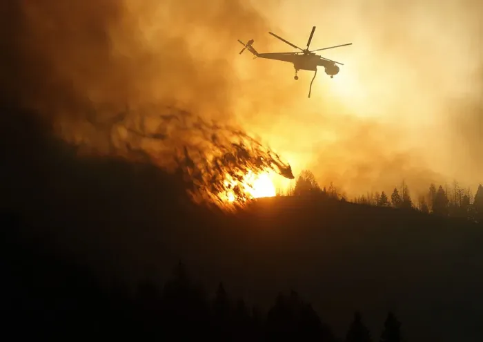 Framed Print : A helicopter air tanker dumps water as the sun sets at the Beaver Creek wildfire outside Framed Print : A helicopter air tanker dumps water as the sun sets at the Beaver Creek wildfire outside
