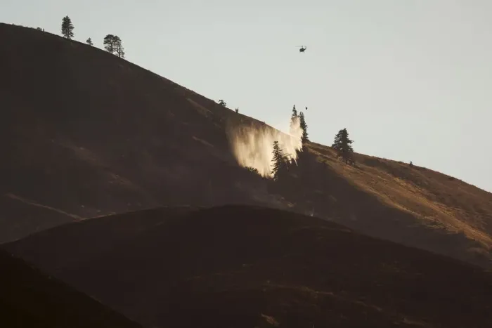Framed Print : A helicopter drops water onto flames from the Sleepy Hollow fire in Wenatchee, Washington